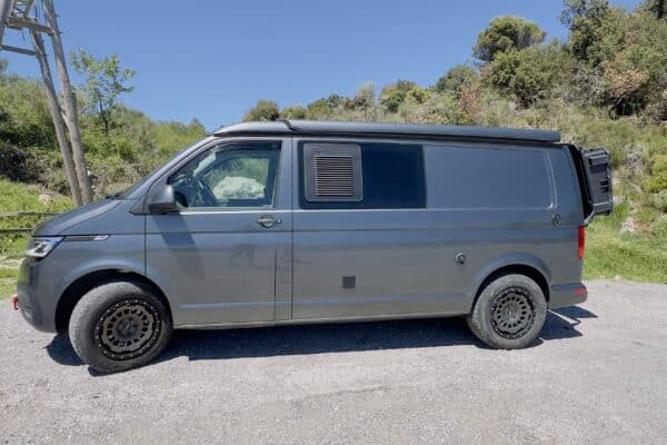 Kastenwagen grau auf einer Landstraße.