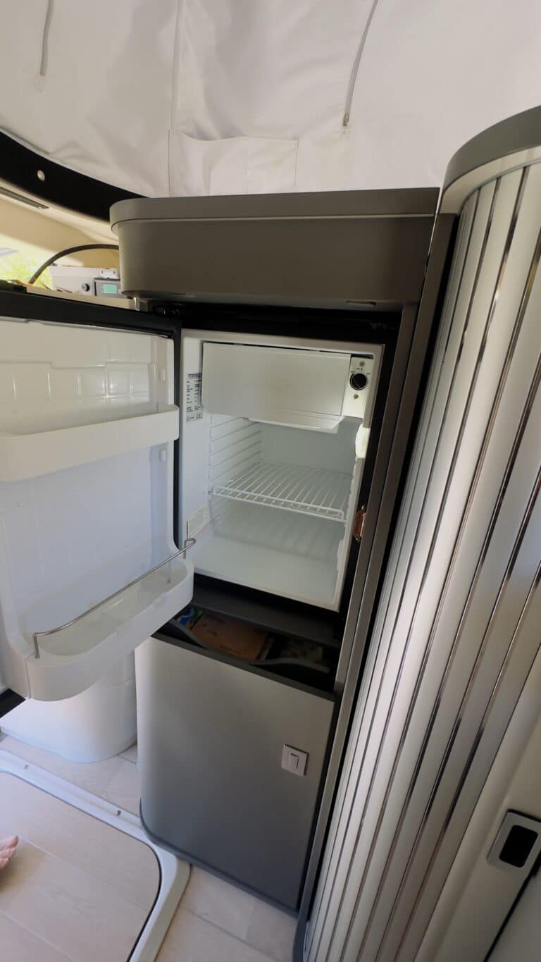 Réfrigérateur ouvert dans camping-car moderne.