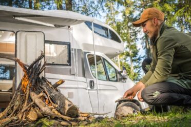 Men Hanging Out Near Campfire and Camping in His Camper Van