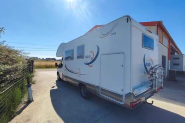 Camping-car stationné à côté d'un bâtiment rural