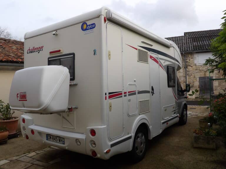 Camping-car blanc Challenger garé dans une cour