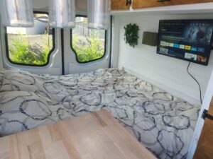 Intérieur moderne de van aménagé avec lit et TV