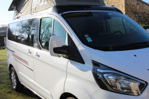 Fourgonnette blanche équipée d'une tente de toit