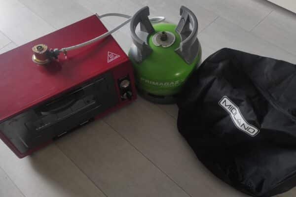 Fornello rosso e bombola del gas verde