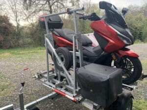Scooter rouge avancé monté sur une remorque