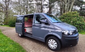 Van gris avec aménagement camping intérieur.