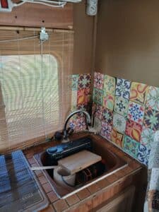 Évier de cuisine avec carreaux colorés et store