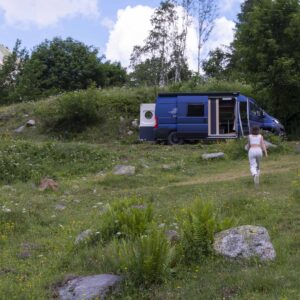 Van aménagé stationné dans une prairie verdoyante