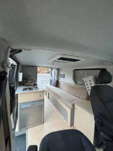 Intérieur aménagé de van avec kitchenette et banquette
