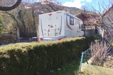 Camper parcheggiato in un giardino soleggiato