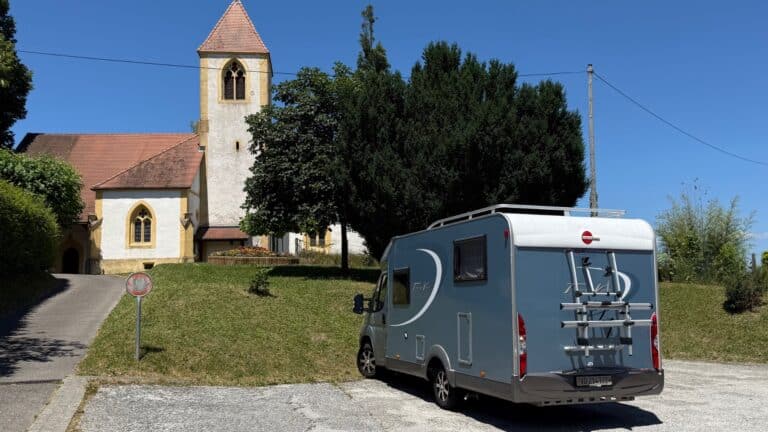 Camping-car garé près d’une église rurale