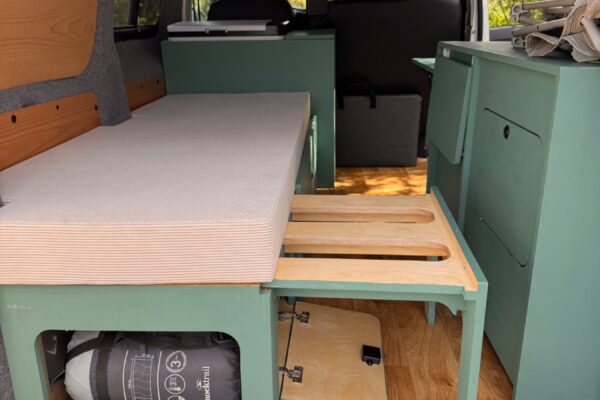 Intérieur de van aménagé avec lit et rangements