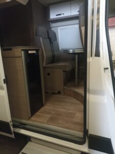 Intérieur de camping-car avec banquette et mini-réfrigérateur