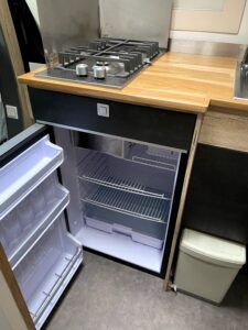 Kitchenette avec plaque gaz et mini-réfrigérateur ouvert