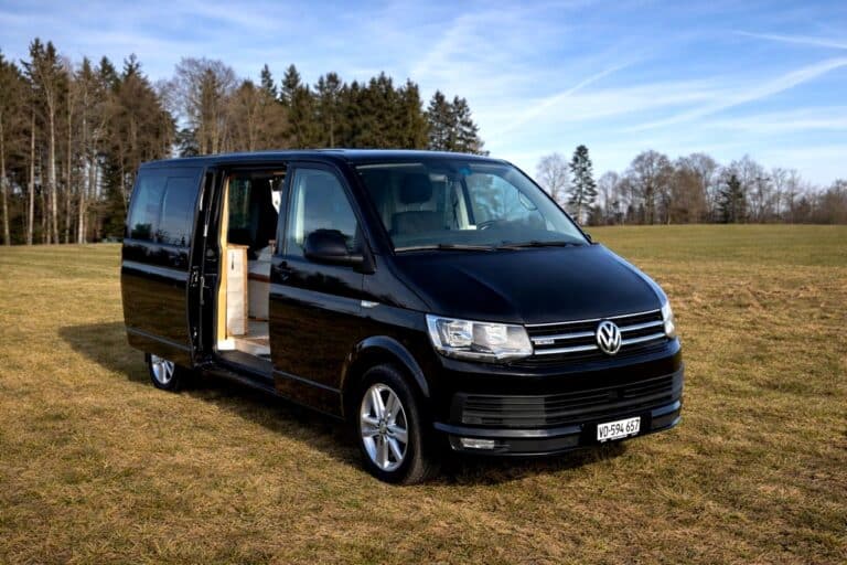 Van Volkswagen noir aménagé en pleine nature