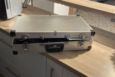 Valise métallique argentée ouverte sur un comptoir