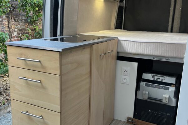 Intérieur aménagé de van avec lit et kitchenette