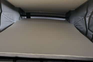 Lit escamotable dans van aménagé avec toit relevable