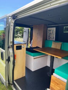 Intérieur aménagé d’un van avec banquettes vertes