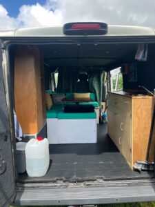 Intérieur aménagé d’un van avec banquette et cuisine