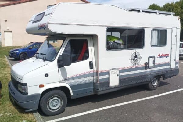 Camping-car blanc garé sur un parking