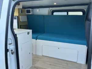 Intérieur de van aménagé avec banquette turquoise