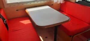 Coin repas camping-car avec banquettes rouges