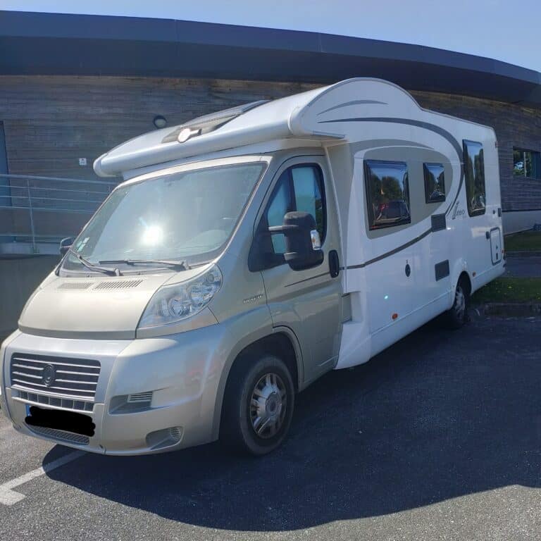 Camping-car stationné devant un bâtiment moderne