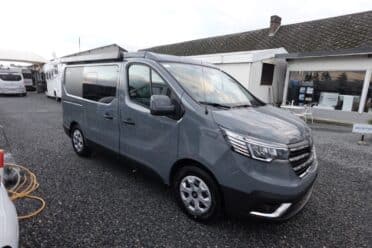 Fourgon gris stationné à l'extérieur concession.