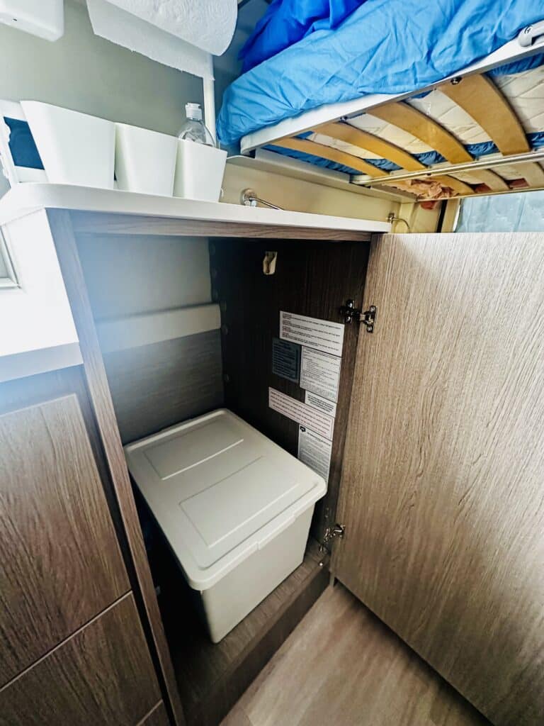 Armoire ouverte avec boîte de rangement beige.